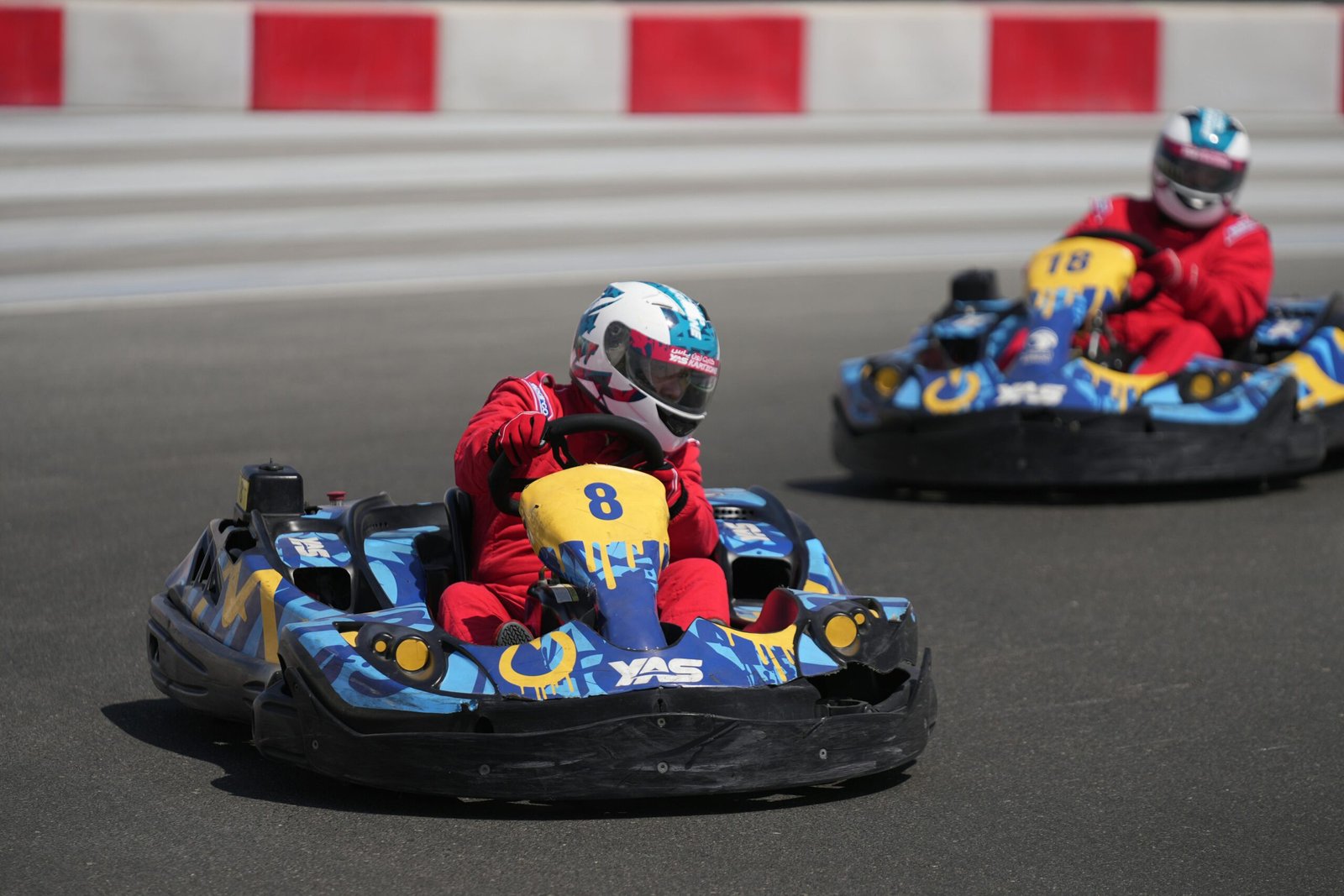 Dynamic go-kart racing action with two drivers speeding at Yas Marina Circuit, Abu Dhabi.